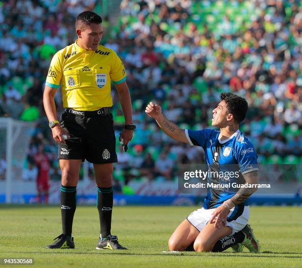 Referee Feranando Guerrero argues with Edson Puch of Queretaro during the 14th round match between Santos Laguna and Querataro as part of the Torneo...