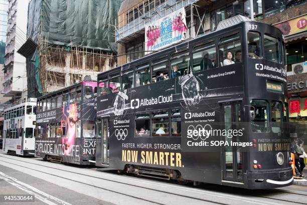 Two-storey trams run on Hennessy road in Wan Chai, Hong Kong.