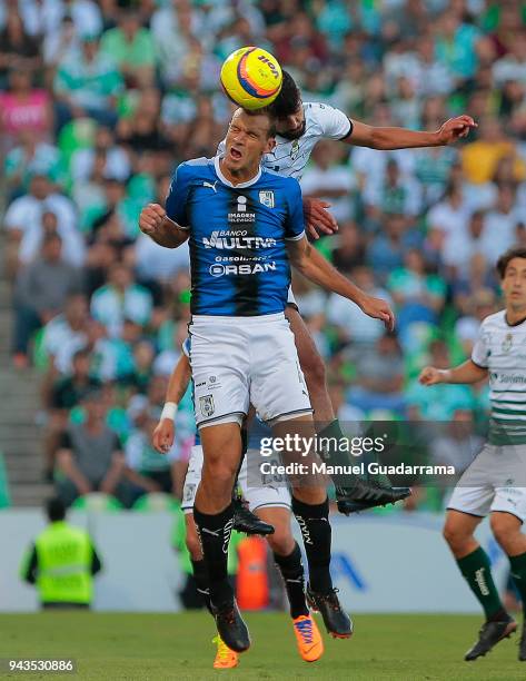 Diego Novaretti of Queretaro fights for the ball with Diego de Buen of Santos during the 14th round match between Santos Laguna and Querataro as part...