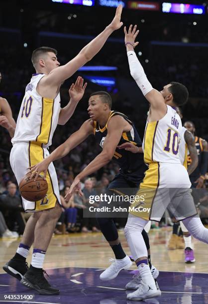 Dante Exum of the Utah Jazz gets past Ivica Zubac of the Los Angeles Lakers and Tyler Ennis in the second half at Staples Center on April 8, 2018 in...