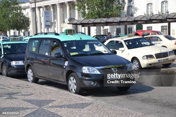 dacia logan mcv taxi waiting for the passengers on the street - renault logan stock pictures, royalty-free photos & images