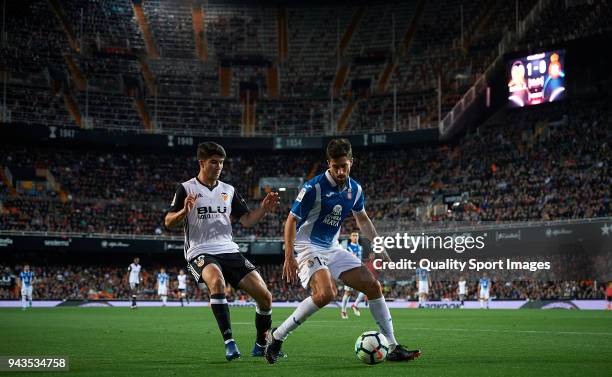 Carlos Soler of Valencia competes for the ball with Didac Vila of Espanyol during the La Liga match between Valencia and Espanyol at Mestalla Stadium...