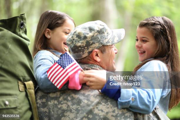family welcomes home usa army soldier. - war memorial holiday stock pictures, royalty-free photos & images