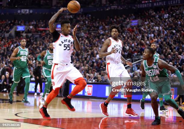 Delon Wright of the Toronto Raptors passes the ball to Lucas Nogueira during the first half of an NBA game against the Boston Celtics at Air Canada...