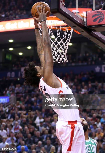 Lucas Nogueira of the Toronto Raptors dunks the ball during the first half of an NBA game against the Boston Celtics at Air Canada Centre on April 4,...