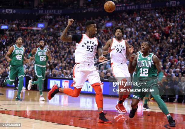 Delon Wright of the Toronto Raptors passes the ball to Lucas Nogueira during the first half of an NBA game against the Boston Celtics at Air Canada...