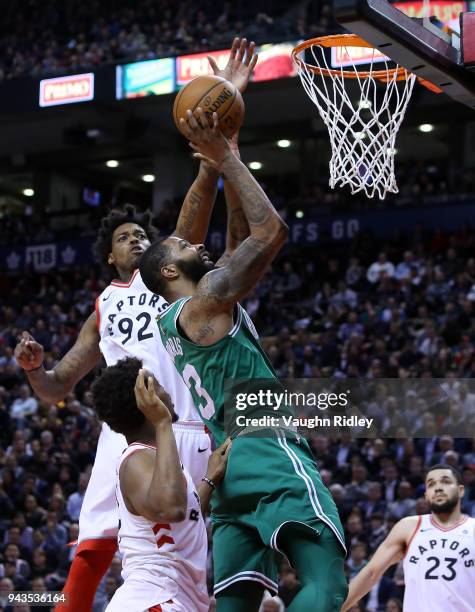 Marcus Morris of the Boston Celtics shoots the ball as Lucas Nogueira of the Toronto Raptors defends during the second half of an NBA game at Air...