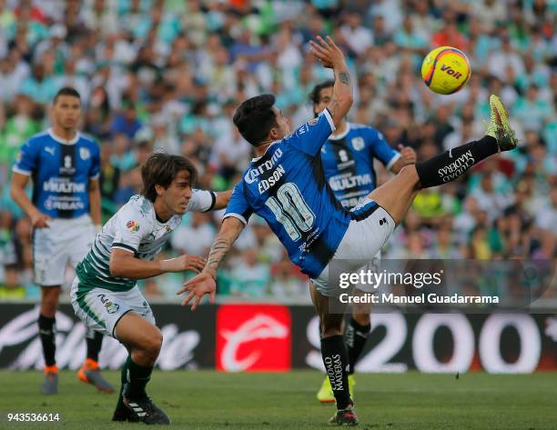 Javier Abella of Santos fights for the ball with Edson Puch of Queretaro during the 14th round match between Santos Laguna and Querataro as part of...