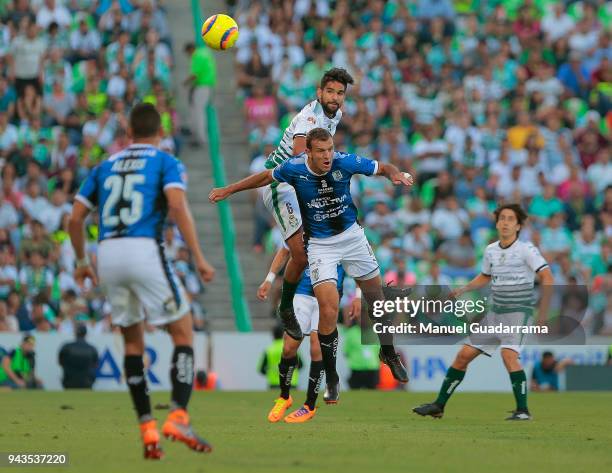 Diego Novaretti of Queretaro fights for the ball with Diego de Buen of Santos during the 14th round match between Santos Laguna and Querataro as part...