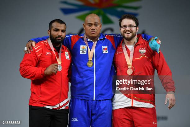 Silver medallist Pardeep Singh of India, gold medallist Sanele Mao of Samoa and bronze medallist Owen Boxall of England pose on the podium for the...