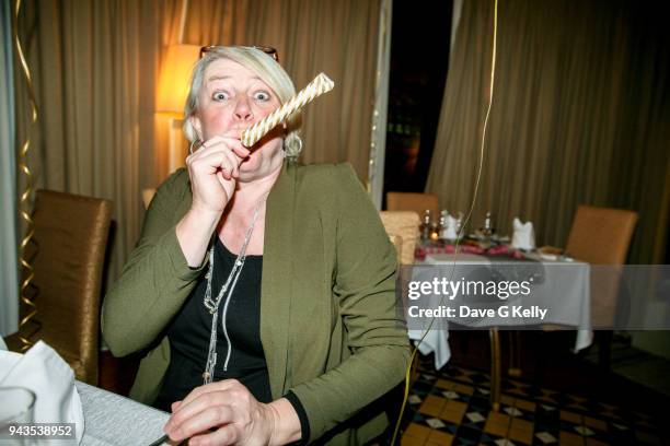 woman celebrating with party blower - matasuegras fotografías e imágenes de stock