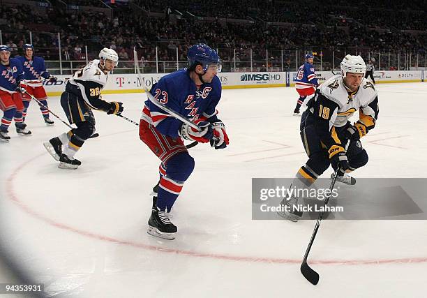 Tim Connolly of the Buffalo Sabres skates the puck away from Chris Drury of the New York Rangers at Madison Square Garden on December 12, 2009 in New...