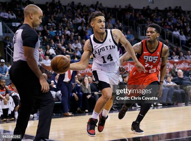 Nick Johnson of the Austin Spurs passes the ball against Alfonzo McKinnie of the Raptors 905 during the NBA G-League Playoffs Game 1 on April 8, 2018...