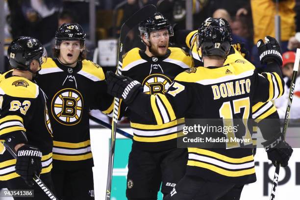 David Pastrnak of the Boston Bruins celebrates with Brad Marchand, Torey Krug and Ryan Donato after scoring a goal against the Florida Panthers...