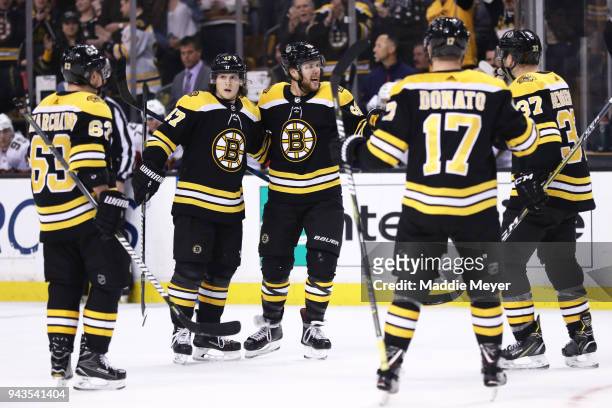 David Pastrnak of the Boston Bruins celebrates with Brad Marchand, Torey Krug and Ryan Donato after scoring a goal against the Florida Panthers...