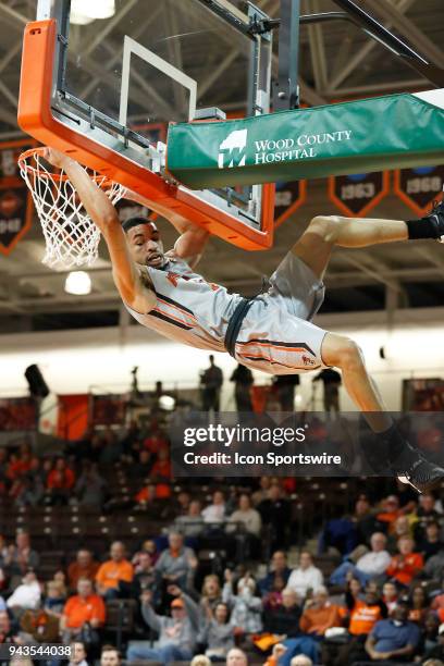 Bowling Green guard Antwon Lillard hangs on the rim for a technical foul after dunking during a game between the Bowling Green State University...