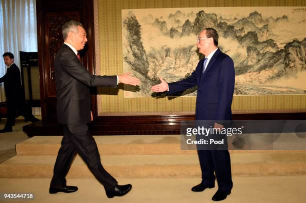 Singapore Prime Minister Lee Hsien Loong shakes hands with Chinese Vice President Wang Qishan during a meeting on April 9, 2018 at the Zhongnanhai...