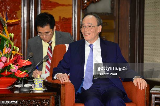 Chinese Vice President Wang Qishan speaks with Singapore's Prime Minister Lee Hsien Loong during their meeting on April 9, 2018 at the Zhongnanhai...