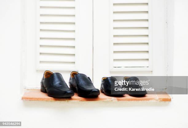 groom and ring bearer shoes on a window sill - ring bearer stockfoto's en -beelden