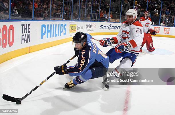 Slava Kozlov of the Atlanta Thrashers carries the puck against Ryan O'Byrne of the Montreal Canadiens at Philips Arena on December 12, 2009 in...