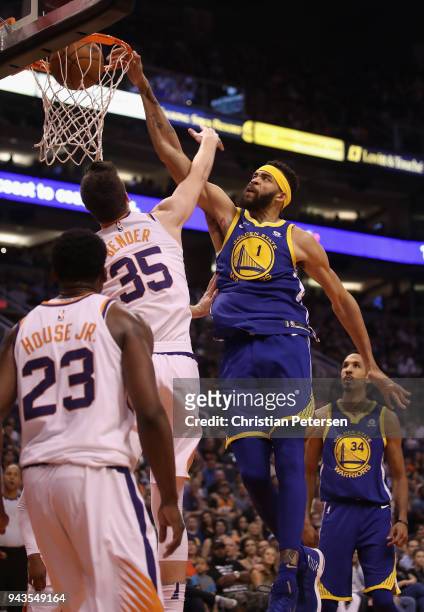 JaVale McGee of the Golden State Warriors slam dunks the ball over Dragan Bender of the Phoenix Suns during the first half of the NBA game at Talking...