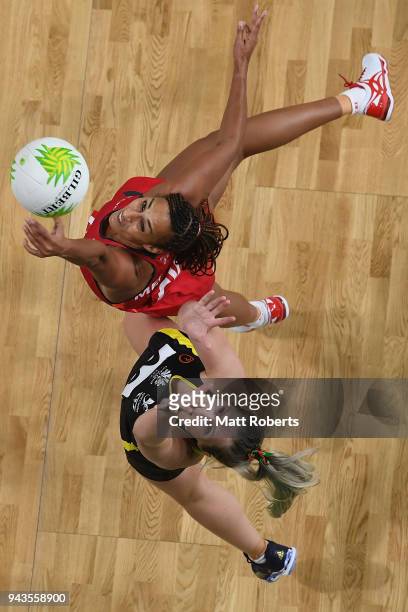 Geva Mentor of England competes for the ball against Chelsea Lewis of Wales during to the Netball Preliminary round match between England and Wales...