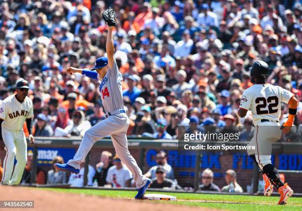 Los Angeles Dodgers Infield Enrique Hernandez completes the play for a first base out against San Francisco Giants Pitcher Cory Gearrin during a...