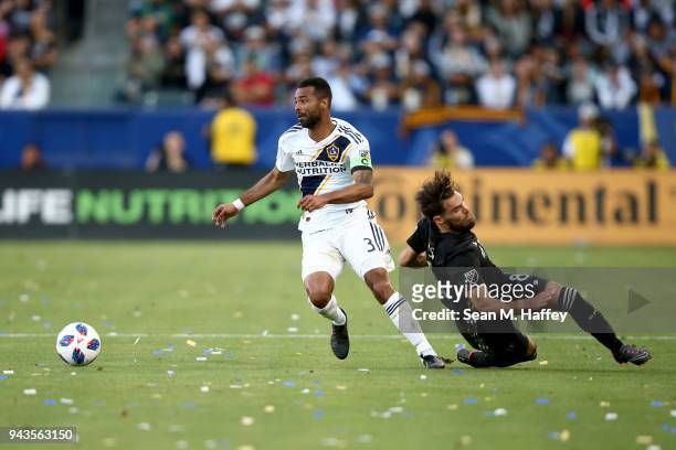 Ashley Cole of Los Angeles Galaxy dribbles past Graham Zusi of Sporting Kansas City during the first half of a game at StubHub Center on April 8,...