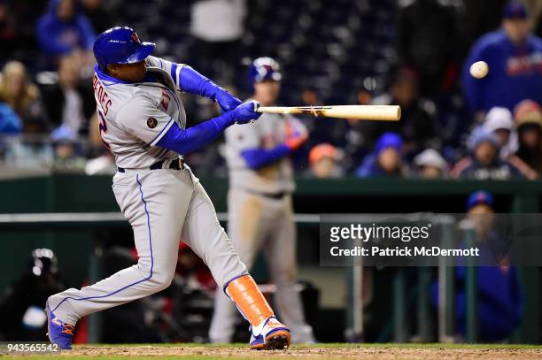 Yoenis Cespedes of the New York Mets hits an RBI single scoring Juan Lagares in the twelfth inning against the Washington Nationals at Nationals Park...