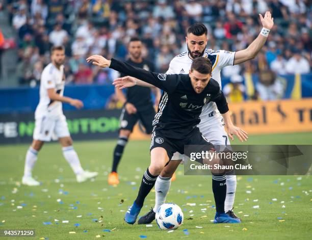 Ilie Sanchez of Sporting Kansas City battles Romain Alessandrini of Los Angeles Galaxy during the Los Angeles Galaxy's MLS match against Sporting...