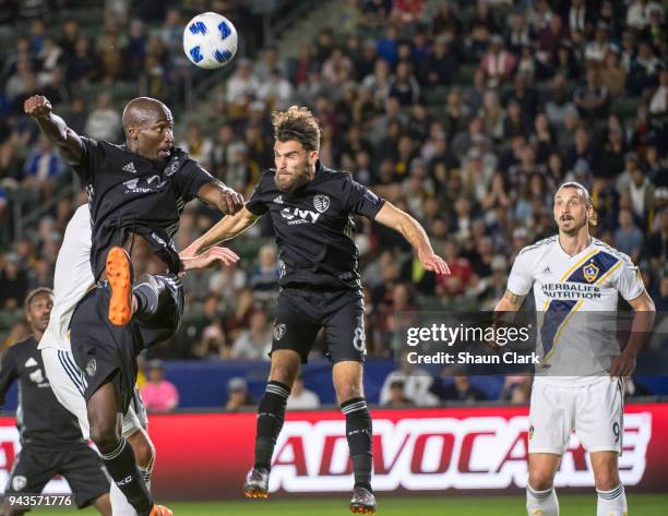 Ike Opara and Matt Besler of Sporting Kansas City defend against Zlatan Ibrahimovic of Los Angeles Galaxy during the Los Angeles Galaxy's MLS match...