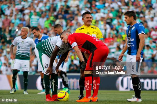 Jorge Djaniny Tavares of Santos, Referee Fernando Guerrero and Tiago Volpi goalkeeper of Queretaro look on before a penalty kick during the 14th...