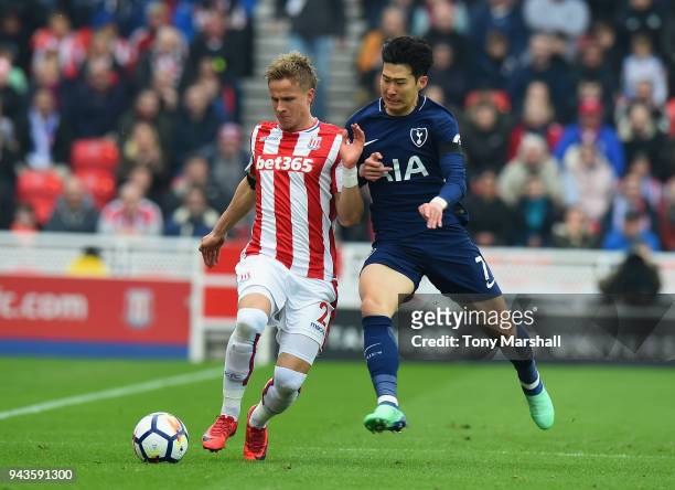 Moritz Bauer of Stoke City is tackled by Son-Heung Min of Tottenham Hotspur during the Premier League match between Stoke City and Tottenham Hotspur...