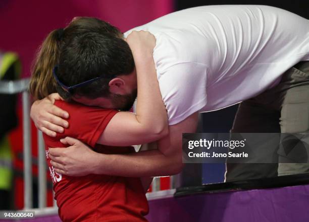 Tesni Evans of Wales celebrates with boyfriend Ben Murphy after winning bronze against Nicol David of Malaysia during squash in the women single...