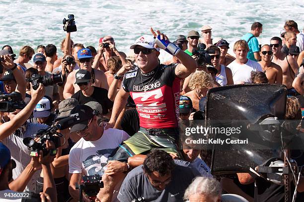 Mick Fanning of Australia is chaired up the beach by his best friends and fellow Australians Joel Parkinson and Dean Morrsion after Round 4 of the...