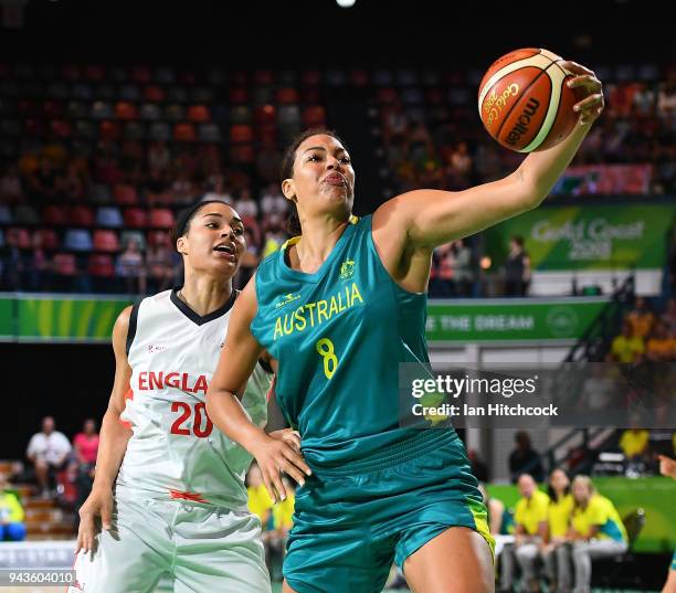 Elizabeth Cambage of Australia catchs the ball in front of Dominique Allen of England during the Preliminary Basketball round match between Australia...