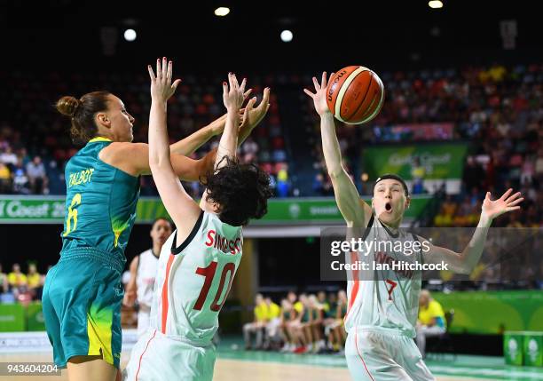 Stephanie Talbot of Australia passes the ball over Eilidh Simpson and Rachael Vanderwal of England during the Preliminary Basketball round match...