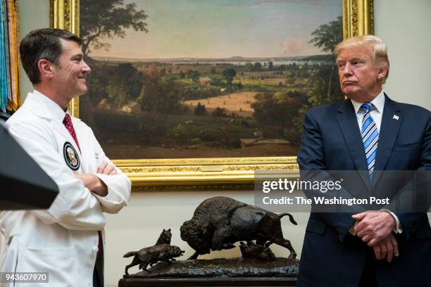 President Donald Trump looks to White House physician Ronny Jackson during a Veterans Affairs Department "telehealth" event in the Roosevelt Room of...