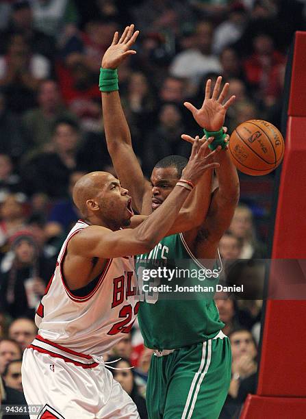 Taj Gibson of the Chicago Bulls looses control of the ball under pressure from Sheldon Williams of the Boston Celtics at the United Center on...