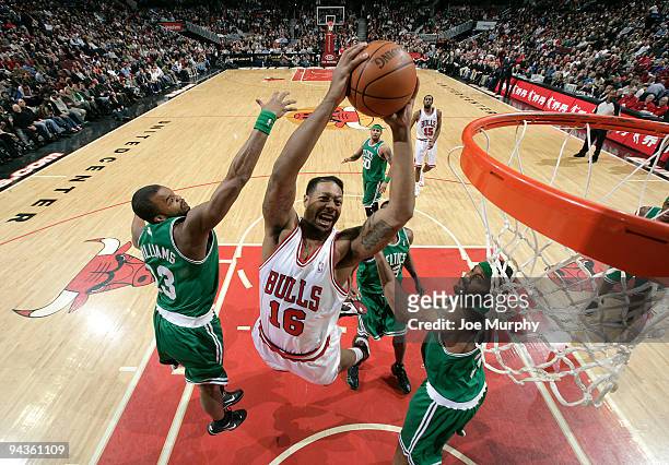 James Johnson of the Chicago Bulls goes to the basket over Shelden Williams and Rasheed Wallace of the Boston Celtics during the NBA game on December...