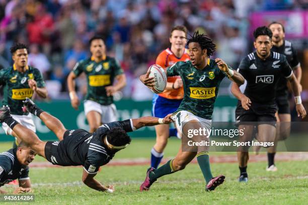 Amanaki Nicole of New Zealand tris to tackle Stedman Gans of South Africa during the HSBC Hong Kong Sevens 2018 Bronze Medal Final match between...