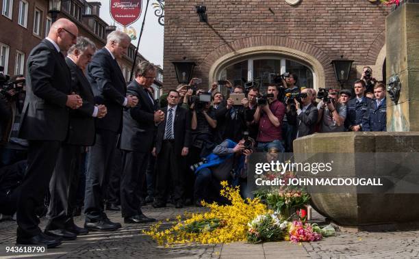 German Interior Minister Horst Seehofer and State leader in North Rhine-Westphalia Armin Laschet pay their respect at a makeshift memorial at the...