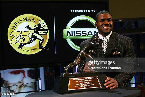 Running back Mark Ingram of the Alabama Crimson Tide poses with the Heisman Trophy during a press conference after being named the 75th Heisman...