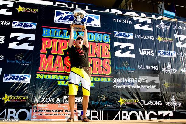 Mick Fanning of Australia hoists his ASP World Title trophy after winning his second ASP World Title at the Billabong Pipeline Masters on December...
