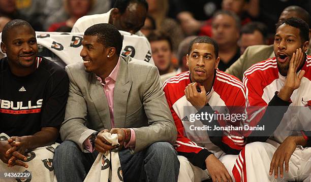 Lindsey Hunter, Tyrus Thomas, Jannero Pargo and James Johnson of the Chicago Bulls sit on the bench during a game against the Boston Celtics at the...