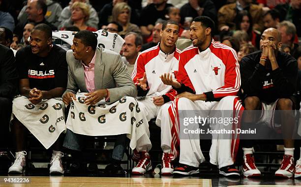 Lindsey Hunter, Tyrus Thomas, Jannero Pargo, James Johnson and Taj Gibson of the Chicago Bulls sit on the bench during a game against the Boston...