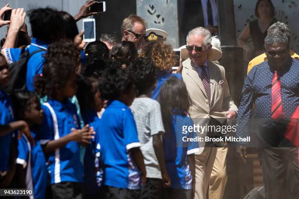 Prince Charles, Prince of Wales is greeted by local students as he departs the Buku-Larrnggay Centre on April 9, 2018 in Gove, Australia. The Prince...