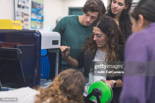 ethnic teacher shows her class how to use a 3d printer - camera 3d render stock pictures, royalty-free photos & images