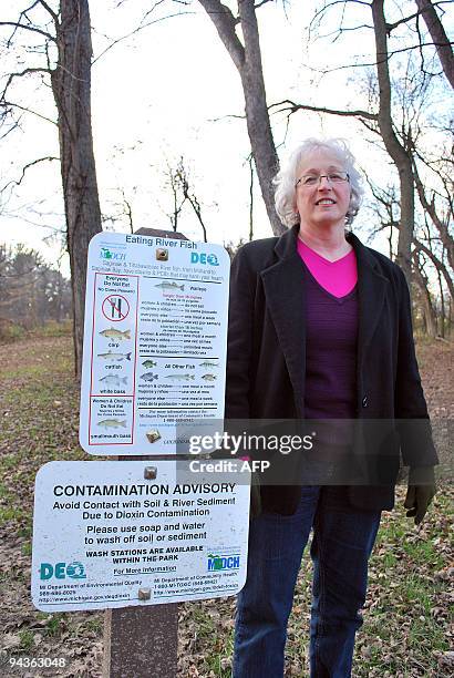 By Mira Oberman, US-environment-pollution-company-Dow Environmental activist Michelle Hurd Riddick of the Lone Tree Council stands next to a sign...