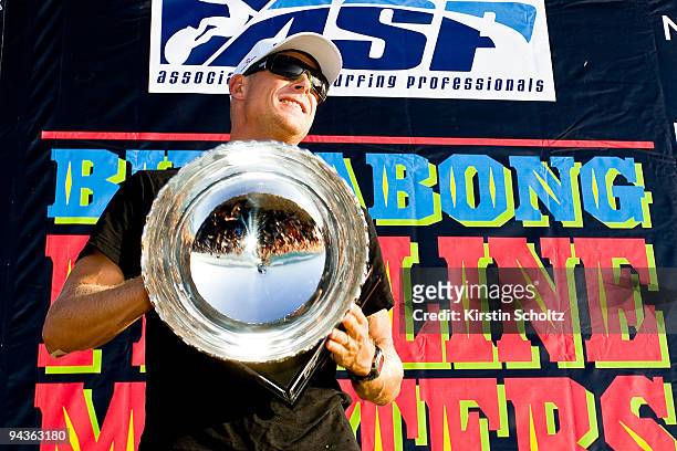 Mick Fanning of Australia with the crowd reflected in his ASP World Title trophy at the Billabong Pipeline Masters on December 12, 2009 in Pipeline,...